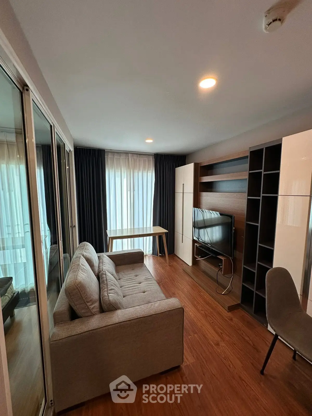 Modern living room with sleek furniture and natural light, perfect for cozy relaxation and entertainment.