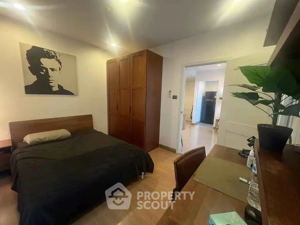 Cozy bedroom with wooden furniture and modern decor in a stylish apartment.