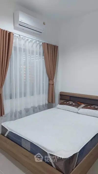 Cozy bedroom with modern air conditioning and elegant curtains