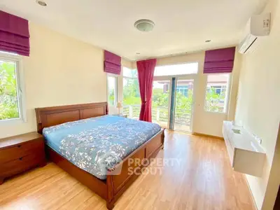Spacious bedroom with balcony access and natural light in modern home.
