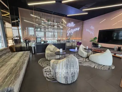 Modern living room with stylish furniture and neon sign, perfect for relaxation and entertainment.