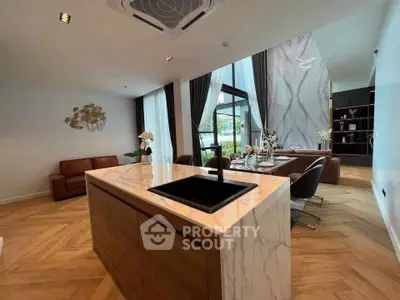 Luxurious open-plan living room with modern kitchen island and elegant decor