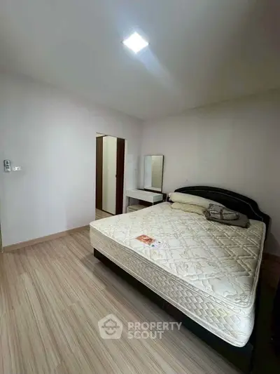 Spacious bedroom with modern decor and comfortable bed in a stylish apartment.