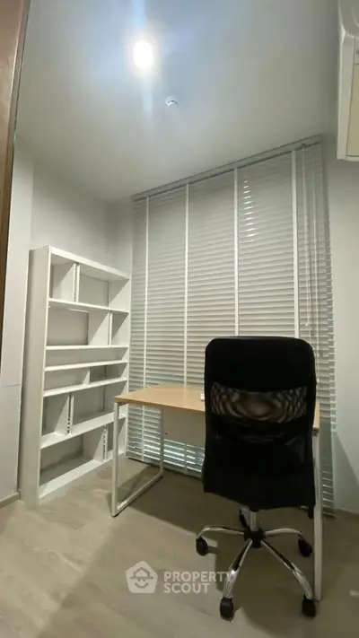 Modern study room with desk, chair, and shelving unit, perfect for productivity.