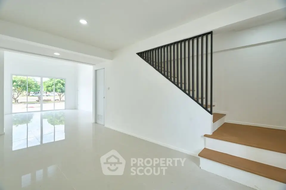 Spacious modern interior with open layout and staircase, perfect for family living.