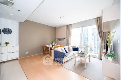 Modern living room with city view, stylish decor, and natural light