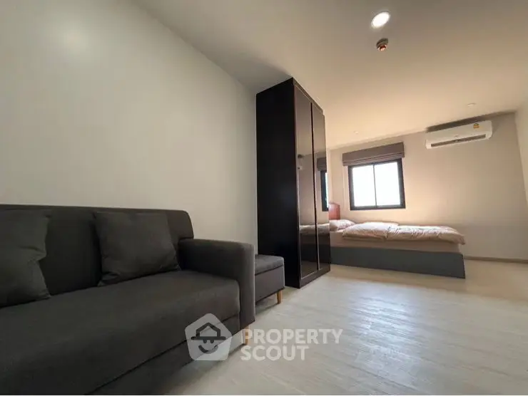 Modern minimalist living room with sleek furniture and ample natural light.