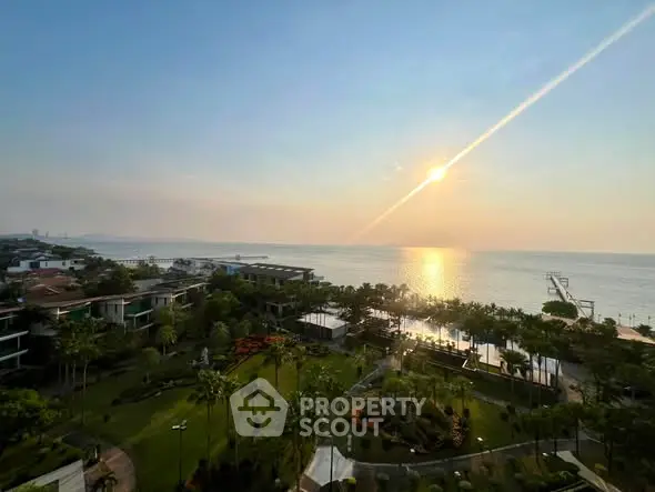 Stunning ocean view from a luxurious property with lush gardens and sunset panorama.