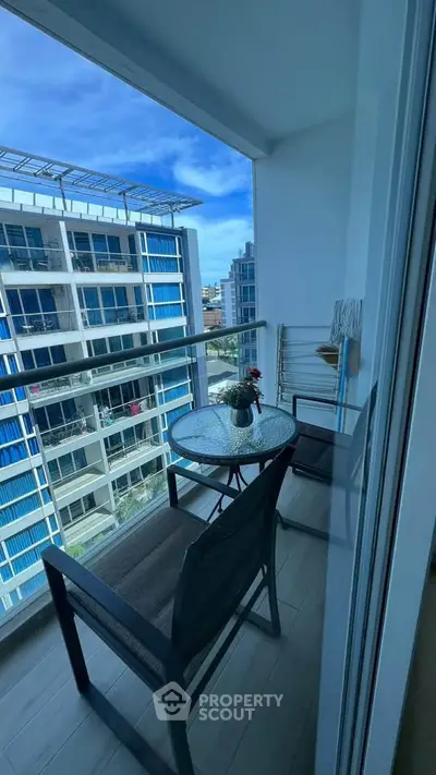 Charming balcony with modern furniture and stunning city view, perfect for relaxation and enjoying the skyline.