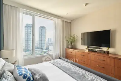 Luxurious bedroom with stunning city view, modern decor, and large window for natural light.