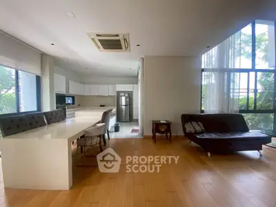 Spacious modern living room with open kitchen and large windows