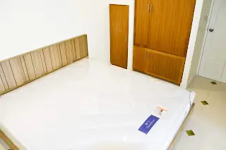 Spacious bedroom with wooden wardrobe and modern design