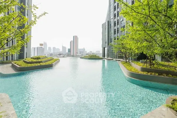 Luxurious rooftop pool with stunning city skyline view in modern high-rise building.