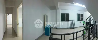 Spacious interior hallway with modern staircase and natural lighting