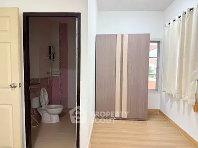 Compact bedroom with ensuite bathroom and wardrobe, ideal for cozy living.