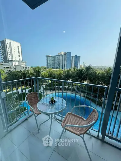 Charming balcony with pool view in modern apartment complex