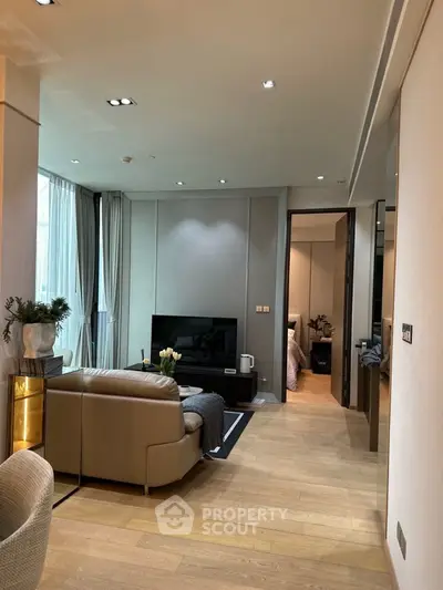 Modern living room with sleek design and cozy ambiance, featuring a stylish sofa and flat-screen TV.