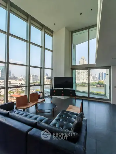 Luxurious living room with stunning city view and modern furnishings.