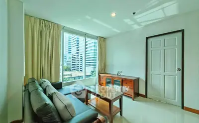 Bright living room with modern furniture and city view, perfect for urban living.
