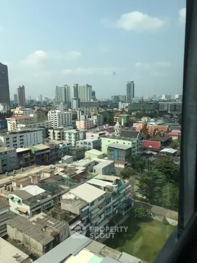 Stunning cityscape view from high-rise apartment window showcasing urban skyline.