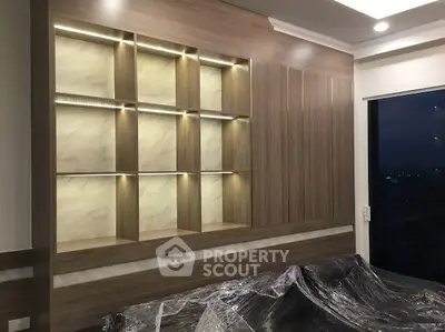 Modern living room with elegant built-in shelving and ambient lighting