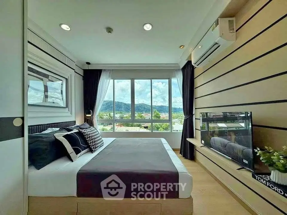 Modern bedroom with large windows and scenic view, featuring stylish decor and ample natural light.