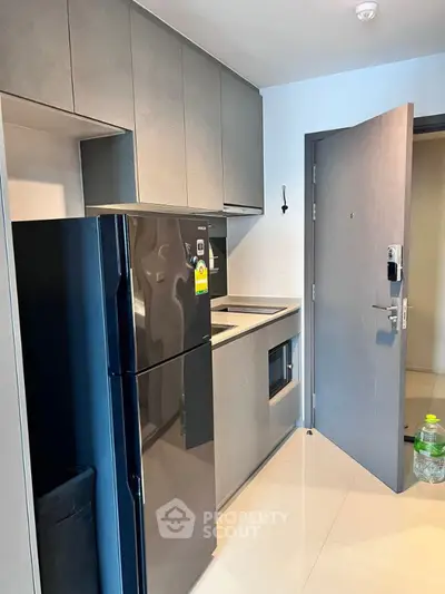 Modern kitchen with sleek appliances and minimalist design in a contemporary apartment.