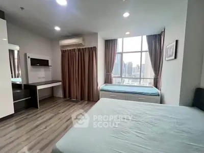 Spacious bedroom with city view, featuring modern decor and ample natural light.