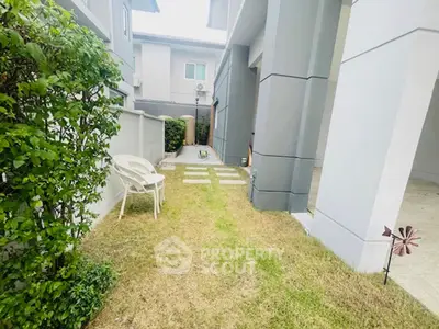 Charming garden area with modern architecture and cozy seating, perfect for relaxation.