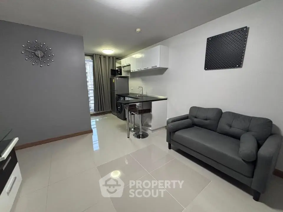 Modern open-plan living room with sleek kitchen and stylish decor