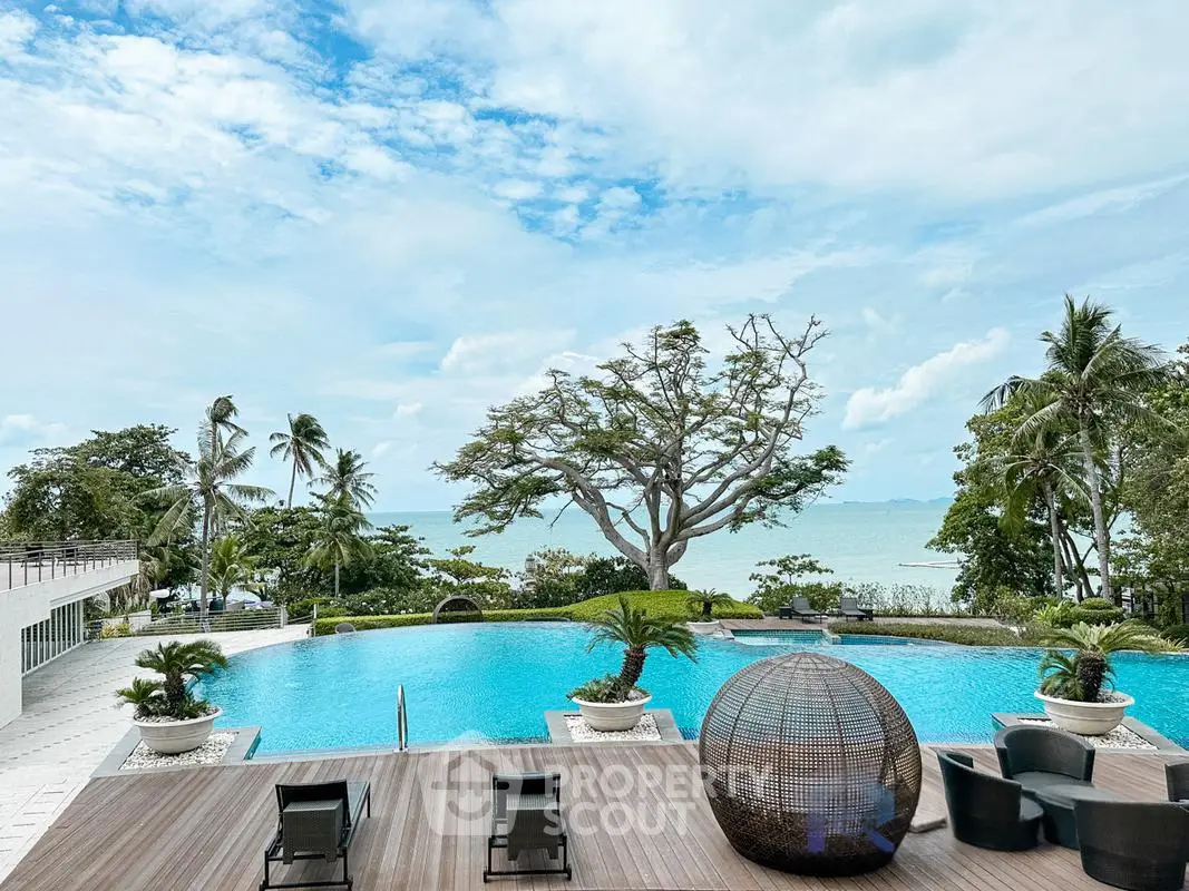 Luxurious beachfront pool with stunning ocean view and lush greenery