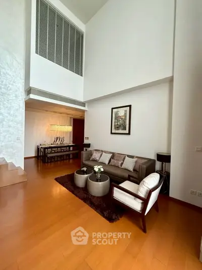 Spacious modern living room with high ceiling and elegant decor