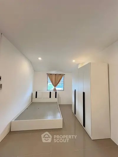 Spacious minimalist bedroom with modern wardrobe and bed frame