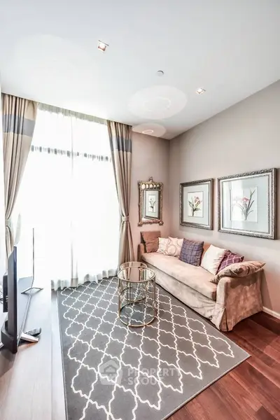 Elegant living room with plush sofa, stylish decor, and large window for natural light.