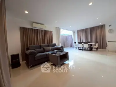 Spacious modern living room with dining area and elegant furnishings