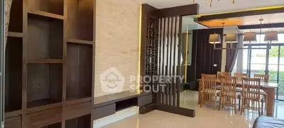 Spacious modern living and dining area with elegant wooden accents and ample natural light.