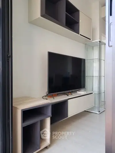Modern living room with sleek TV setup and stylish shelving