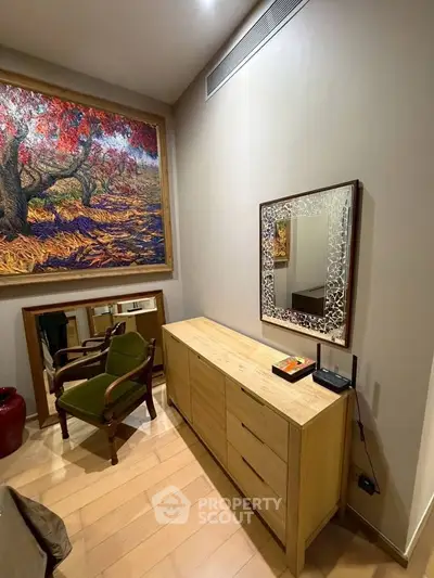 Elegant interior with wooden furniture and artistic wall decor in a cozy living space.