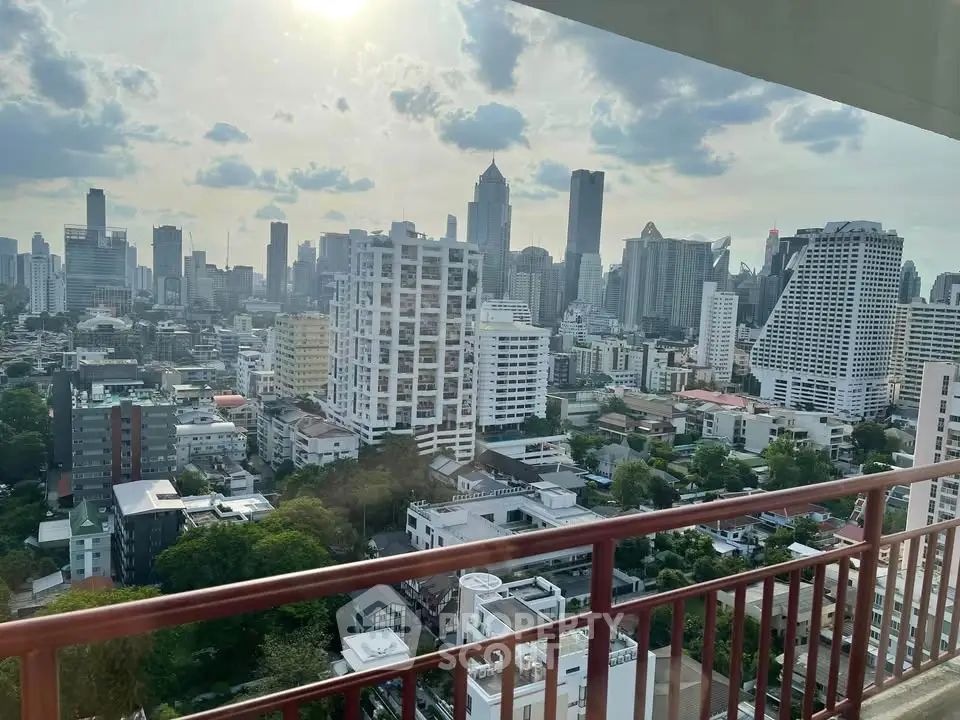 Stunning cityscape view from a high-rise balcony overlooking a vibrant urban skyline.