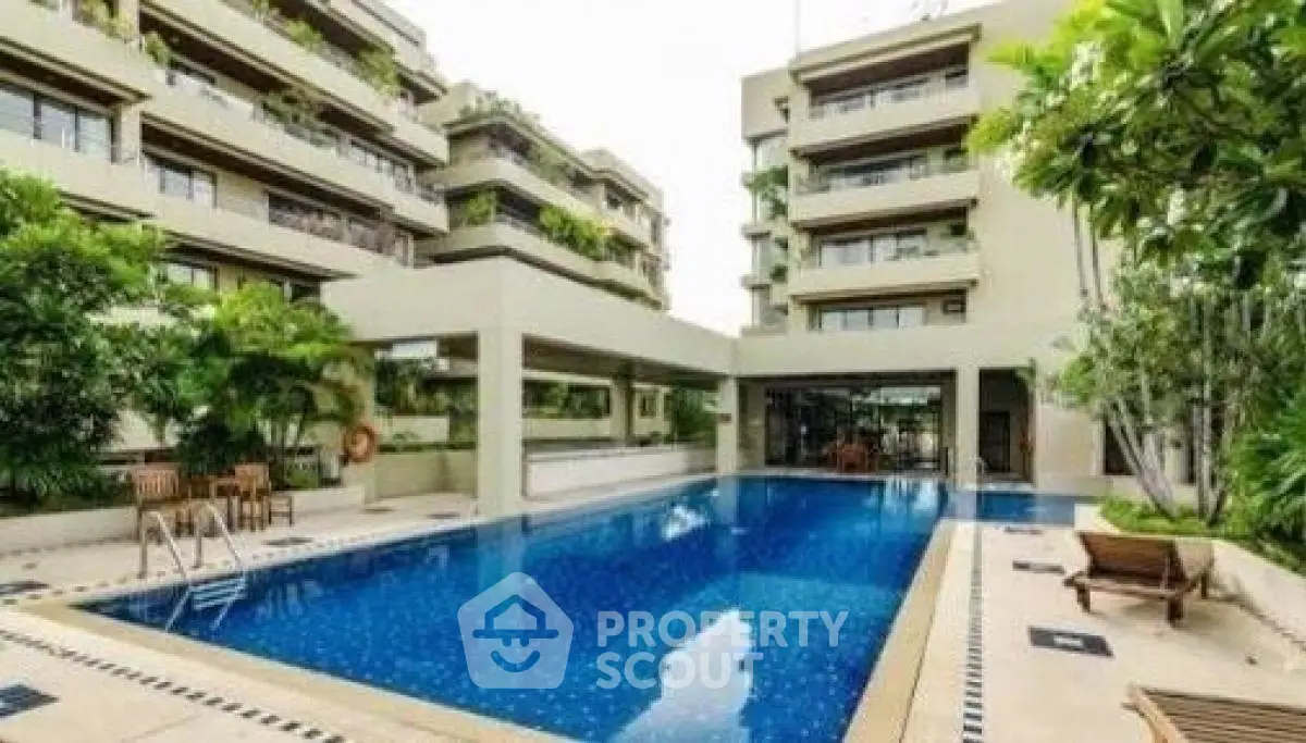 Luxurious residential complex with a stunning outdoor pool and lush greenery
