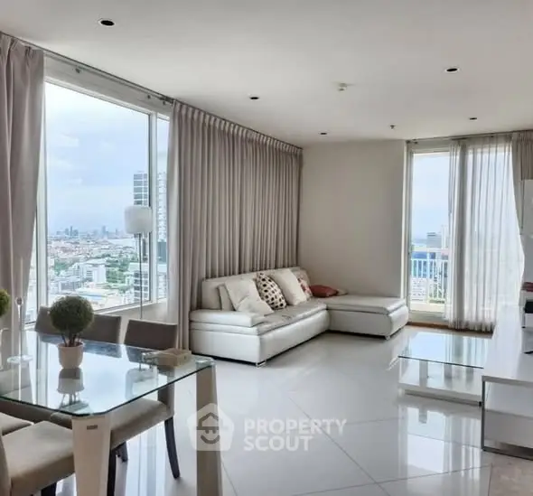 Spacious modern living room with panoramic city view and elegant decor