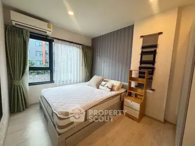 Cozy bedroom with modern decor and large window in urban apartment