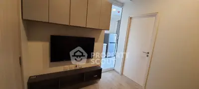 Modern living room with wall-mounted TV and sleek cabinetry