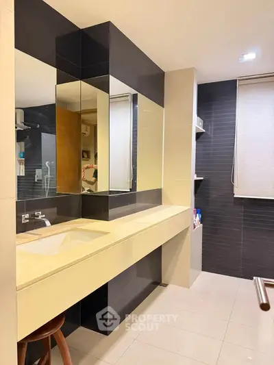Modern bathroom with sleek design and ample storage space.