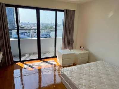 Bright bedroom with balcony and river view in modern apartment