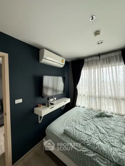 Modern bedroom with large window and wall-mounted TV in stylish apartment