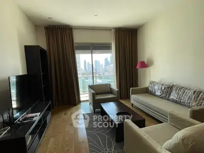 Modern living room with city view, featuring cozy sofas and a large TV, perfect for relaxation.