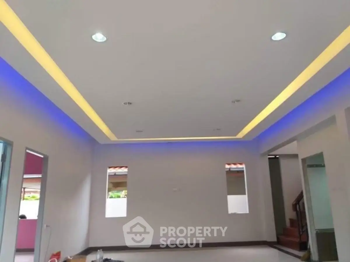 Modern living room with recessed lighting and sleek ceiling design