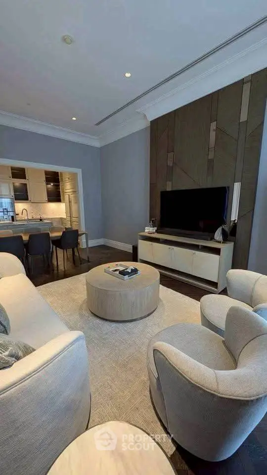 Luxurious living room with modern furniture and open kitchen layout, perfect for stylish urban living.