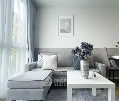 Modern living room with elegant gray sofa and stylish decor